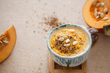 delicious composition with pumpkin soup in a beautiful ceramic dish.